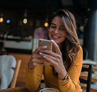 a woman looking at her mobile device