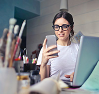 A lady using a smartphone in an art studio