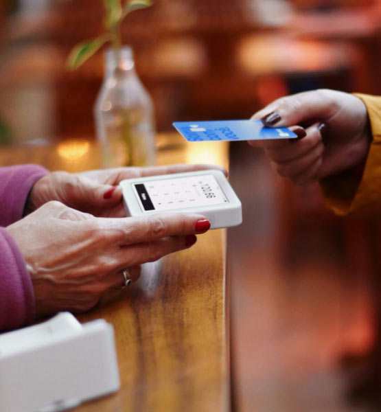 Lady using a card to make a purchase in a store