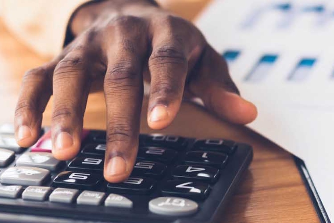 a hand working a calculator