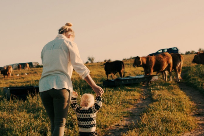 a mother and child walking on a livestock path