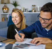 A couple going over financials in their living room