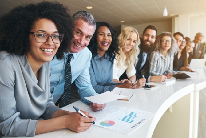 a group of employees taking a team picuture