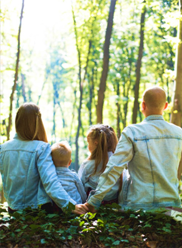 Family sitting in the woods