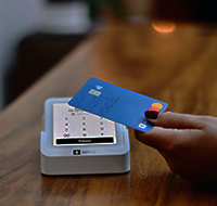 a person paying with their debit/credit card