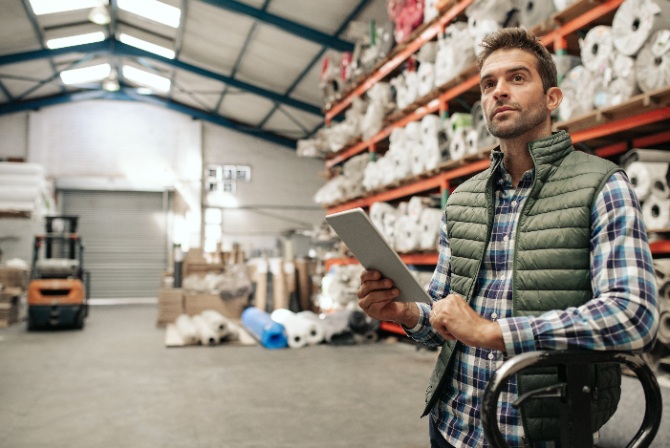 a floor manager looking over inventory