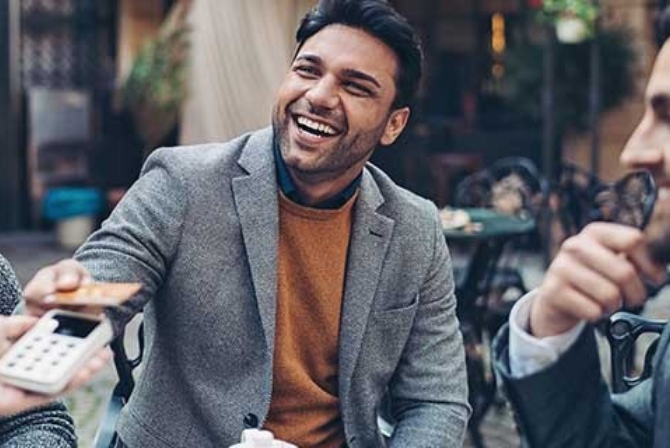 Businessmen paying for food with his credit/debit card